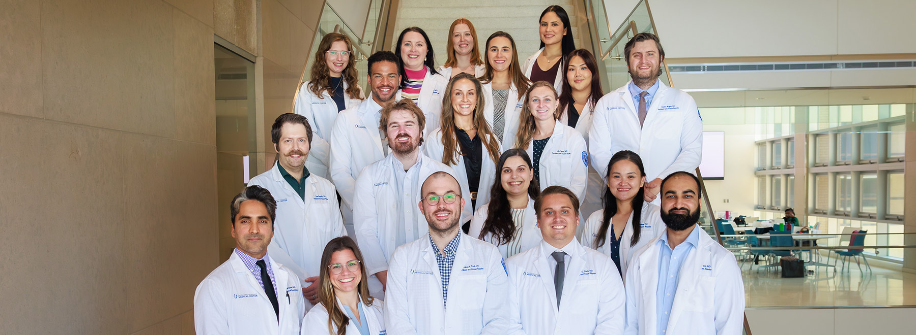 Group portrait of adult psychiatry residents on a staircase.